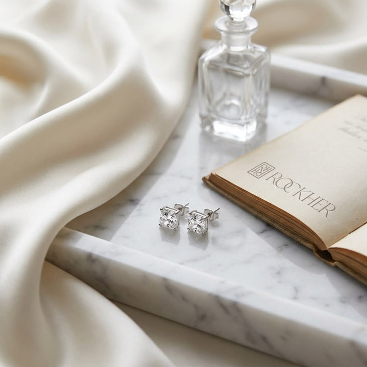 Natural Diamond Round Brilliant Eight Prong Stud Earrings in Platinum, 1 ct. t.w., on marble vanity tray with silk
