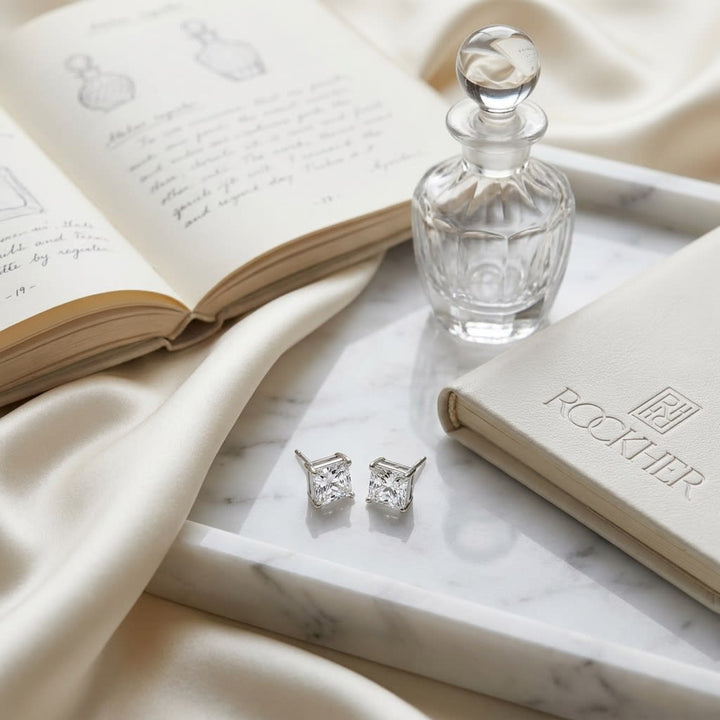 Natural Diamond Round Brilliant Eight Prong Stud Earrings in Platinum, 1 ct. t.w., on marble vanity tray with silk