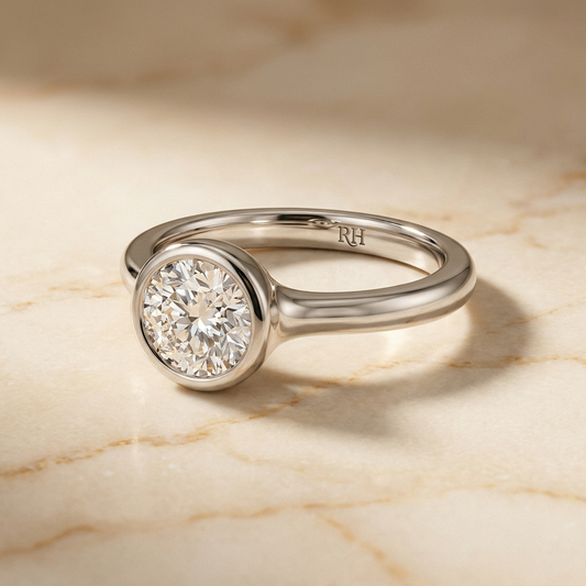 The Agnes bezel solitaire round brilliant engagement ring setting in platinum — alt-angle hero — RockHer