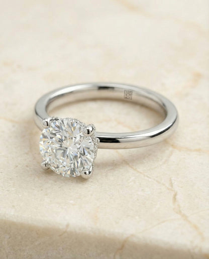 Secret Halo Adorned Prong Solitaire Cushion, in Platinum – lifestyle shot | RockHer