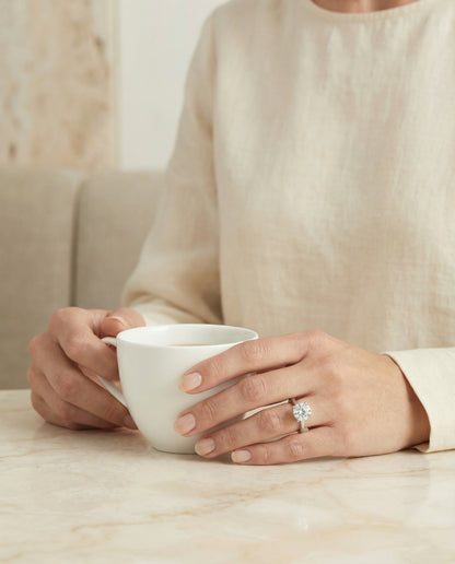 Secret Halo Adorned Prong Solitaire Cushion, in Platinum – lifestyle shot | RockHer
