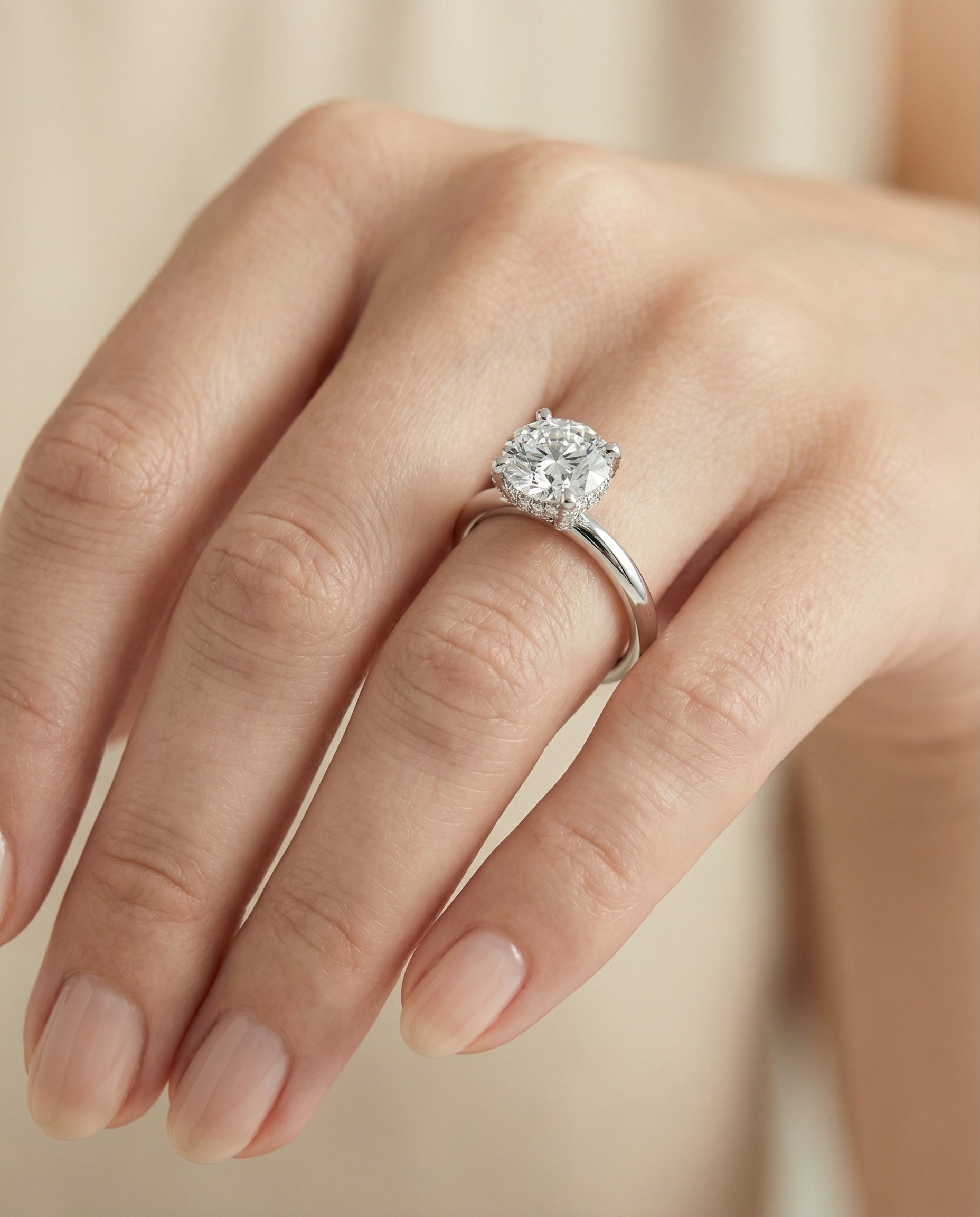 The Lana secret halo adorned prong solitaire cut engagement ring setting, shown in Platinum | RockHer