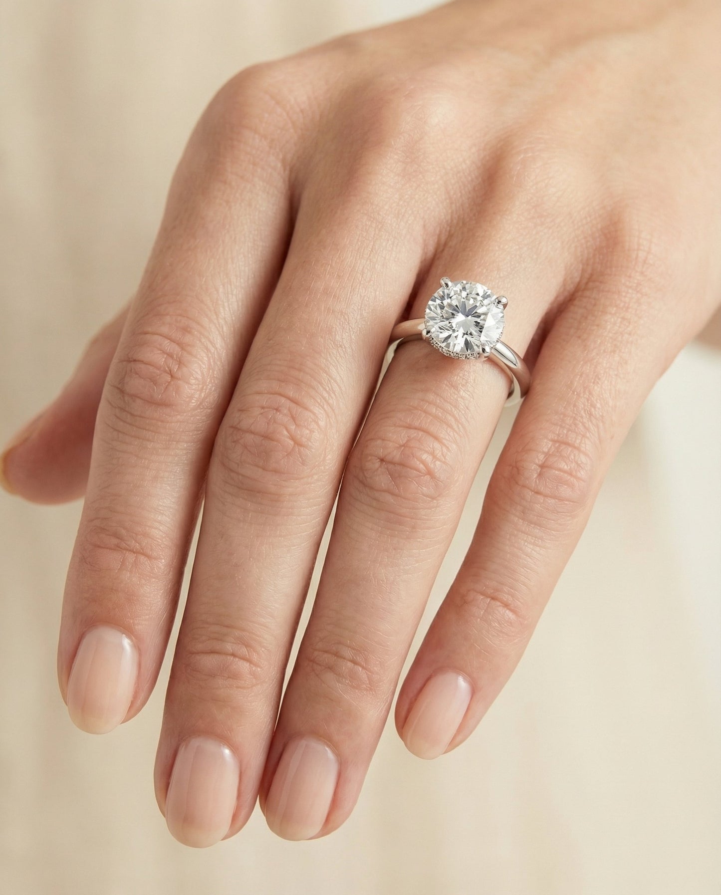 Lana Select secret halo adorned prong solitaire cushion ring in 14K White Gold — on hand — RockHer