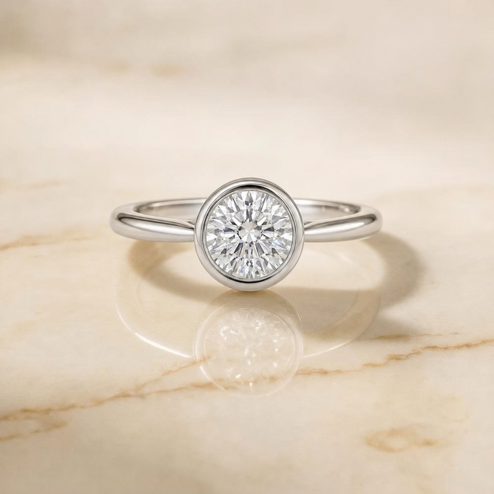 The Duran Simple Bezel Solitaire Round Engagement Ring Setting in 18K White Gold