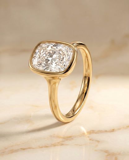 The Agnes Bezel Solitaire In Cushion Cut Engagement Ring Setting in 18K Yellow Gold