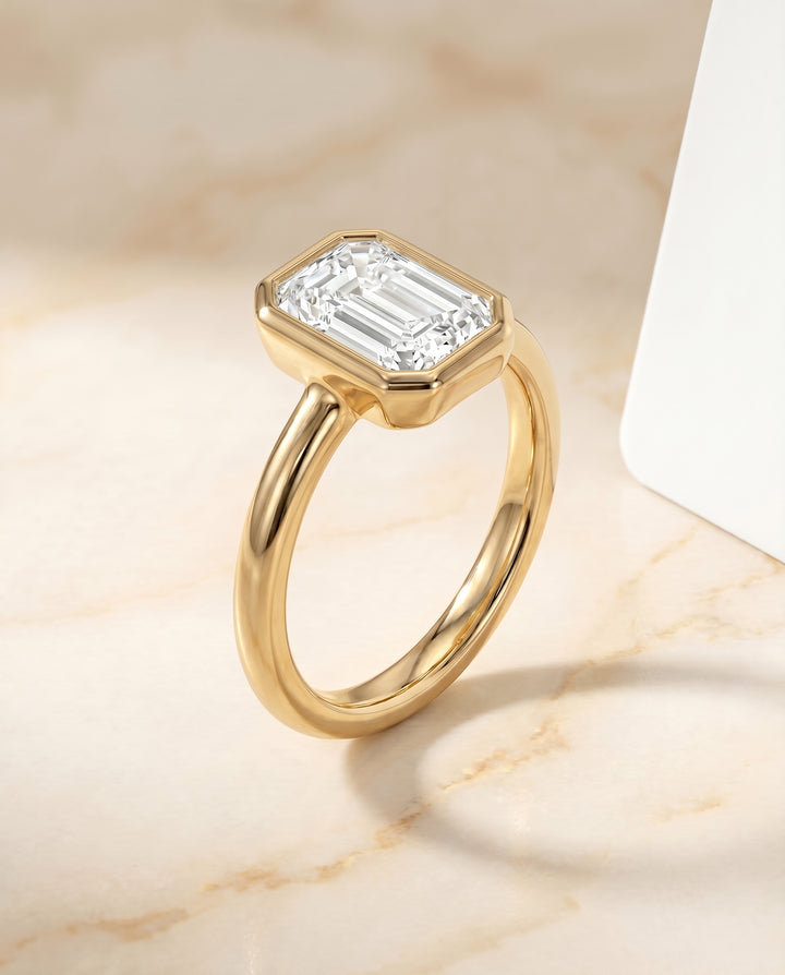 The Agnes Bezel Solitaire In Emerald Cut Engagement Ring Setting in 18K Yellow Gold