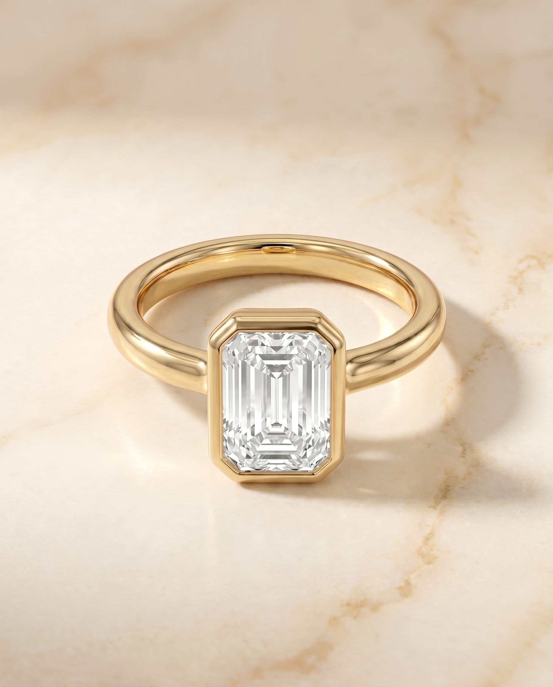 The Agnes Bezel Solitaire Engagement Ring Setting for Emerald Cut Diamonds in 18K Yellow Gold | RockHer