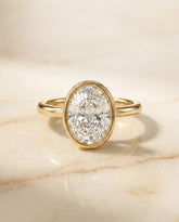 The Agnes Bezel Solitaire Engagement Ring Setting for Oval Diamonds in 18K Yellow Gold | RockHer
