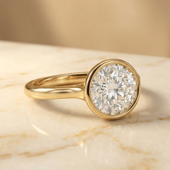 Agnes Round Brilliant Bezel Solitaire in 18K Yellow Gold