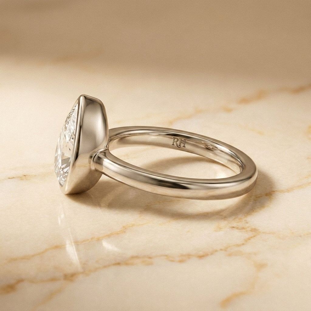 The Agnes Select bezel solitaire briolette engagement ring in 18k white gold — side profile — RockHer
