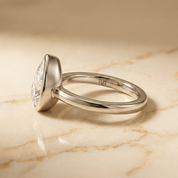 The Agnes Select bezel solitaire briolette engagement ring in platinum — side profile — RockHer