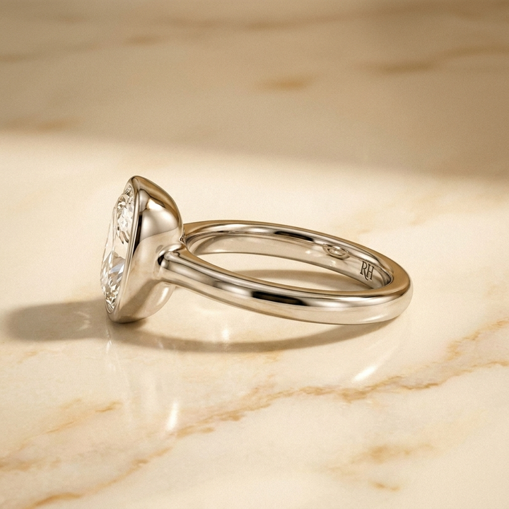 The Agnes Select bezel solitaire cushion engagement ring in 18k white gold — side profile — RockHer