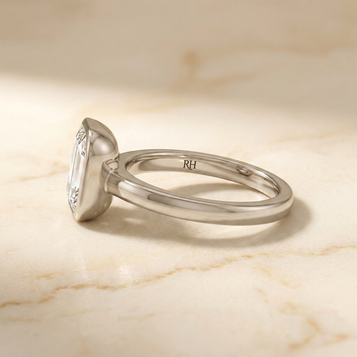 The Agnes Select bezel solitaire emerald cut engagement ring in platinum — side profile — RockHer