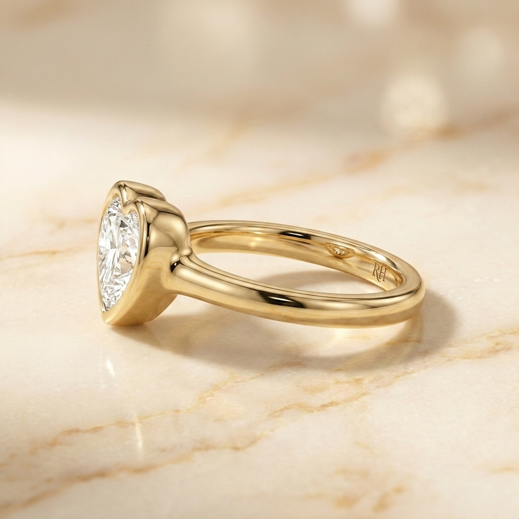 The Agnes Select bezel solitaire heart engagement ring in 18k yellow gold — side profile — RockHer