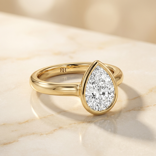 Agnes Pear bezel solitaire engagement ring setting in 18K Yellow Gold — alt-angle hero — RockHer