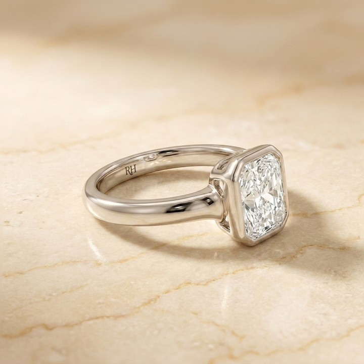 The Agnes Select bezel solitaire radiant engagement ring in 18k white gold — side profile — RockHer