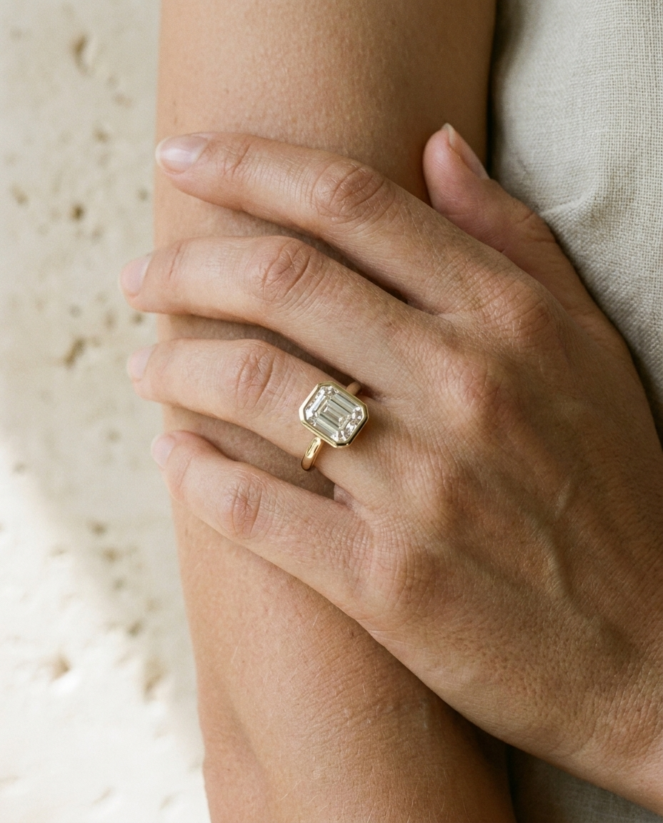 The Agnes Select bezel solitaire square emerald engagement ring in platinum — on hand — RockHer