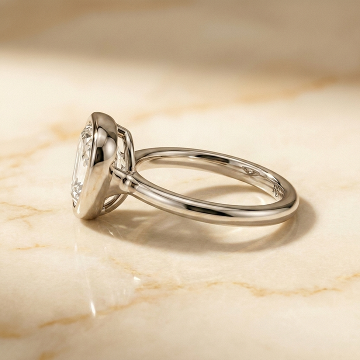 The Agnes Select bezel solitaire shield engagement ring in platinum — side profile — RockHer