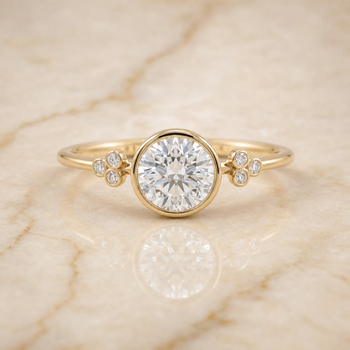 The Selena Clover Bezel Accent Solitaire Round Engagement Ring Setting in 18K Yellow Gold