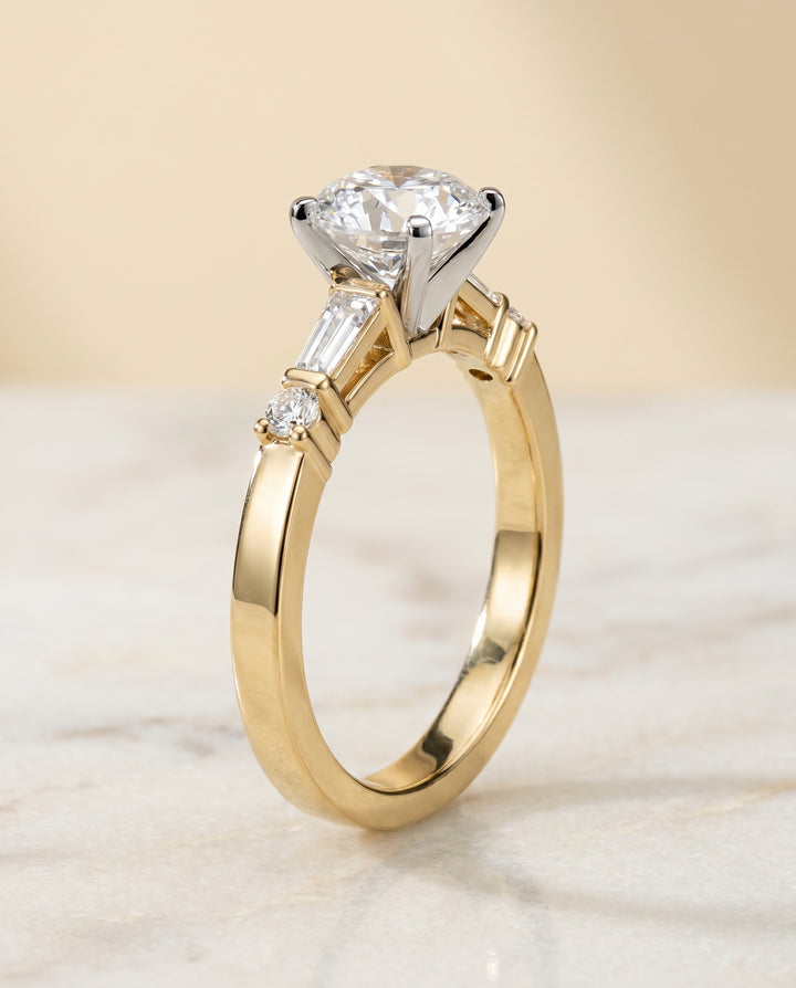 Round Brilliant, Baguette and Round Side Stone, in 18K Yellow Gold – side profile | RockHer