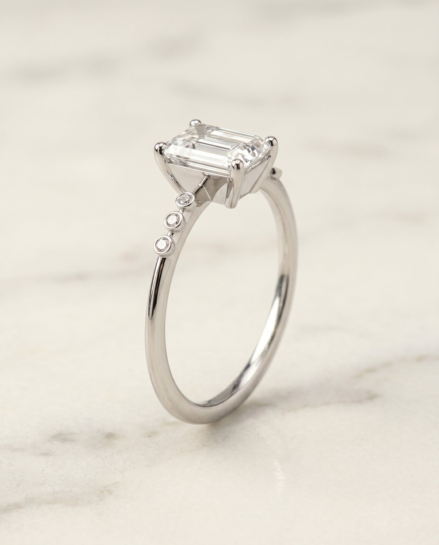 The Peggy Bezel Accent Solitaire Emerald Cut Engagement Ring Setting in Platinum