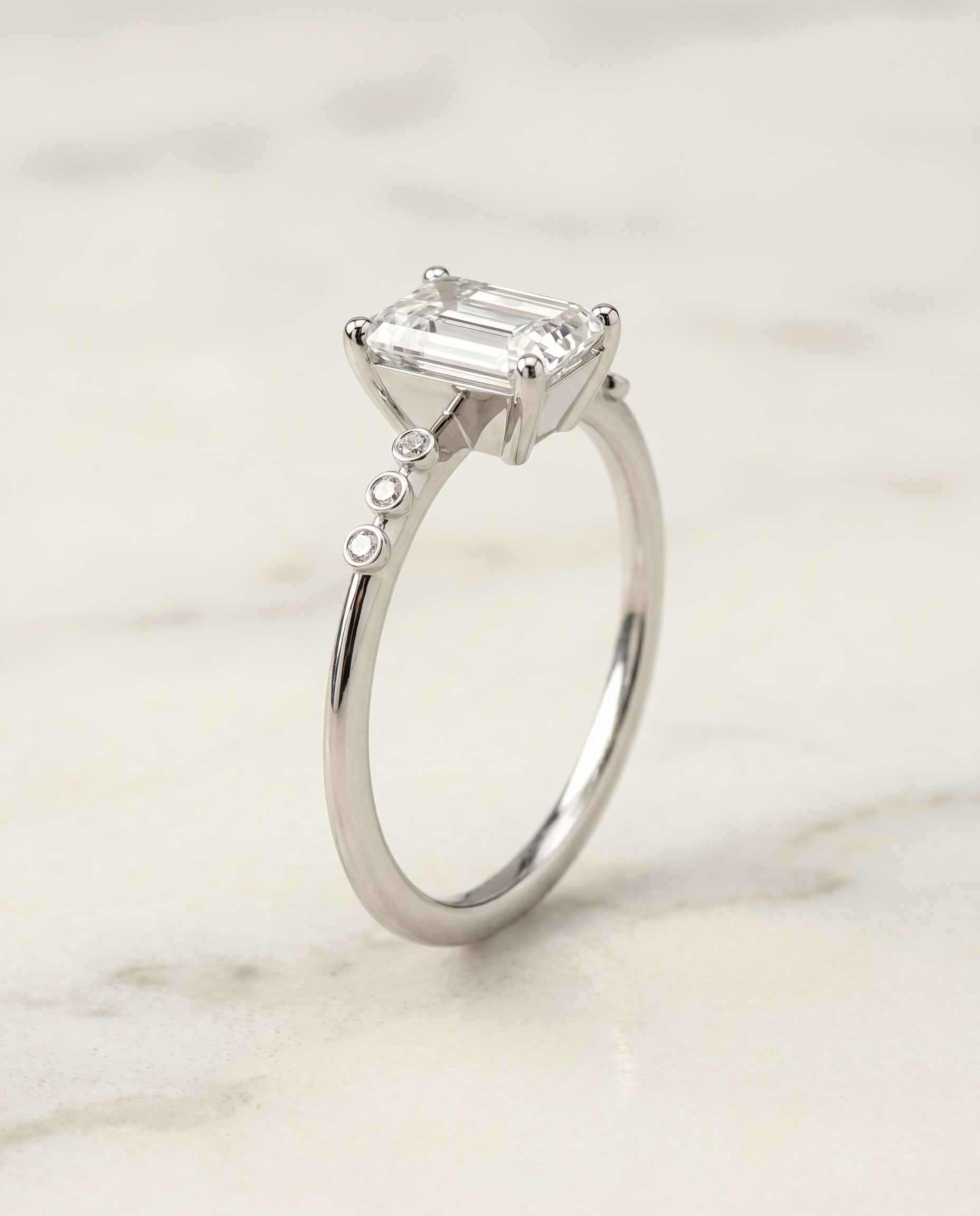 Bezel Accent Solitaire Cut styling on The Peggy emerald engagement ring setting | RockHer