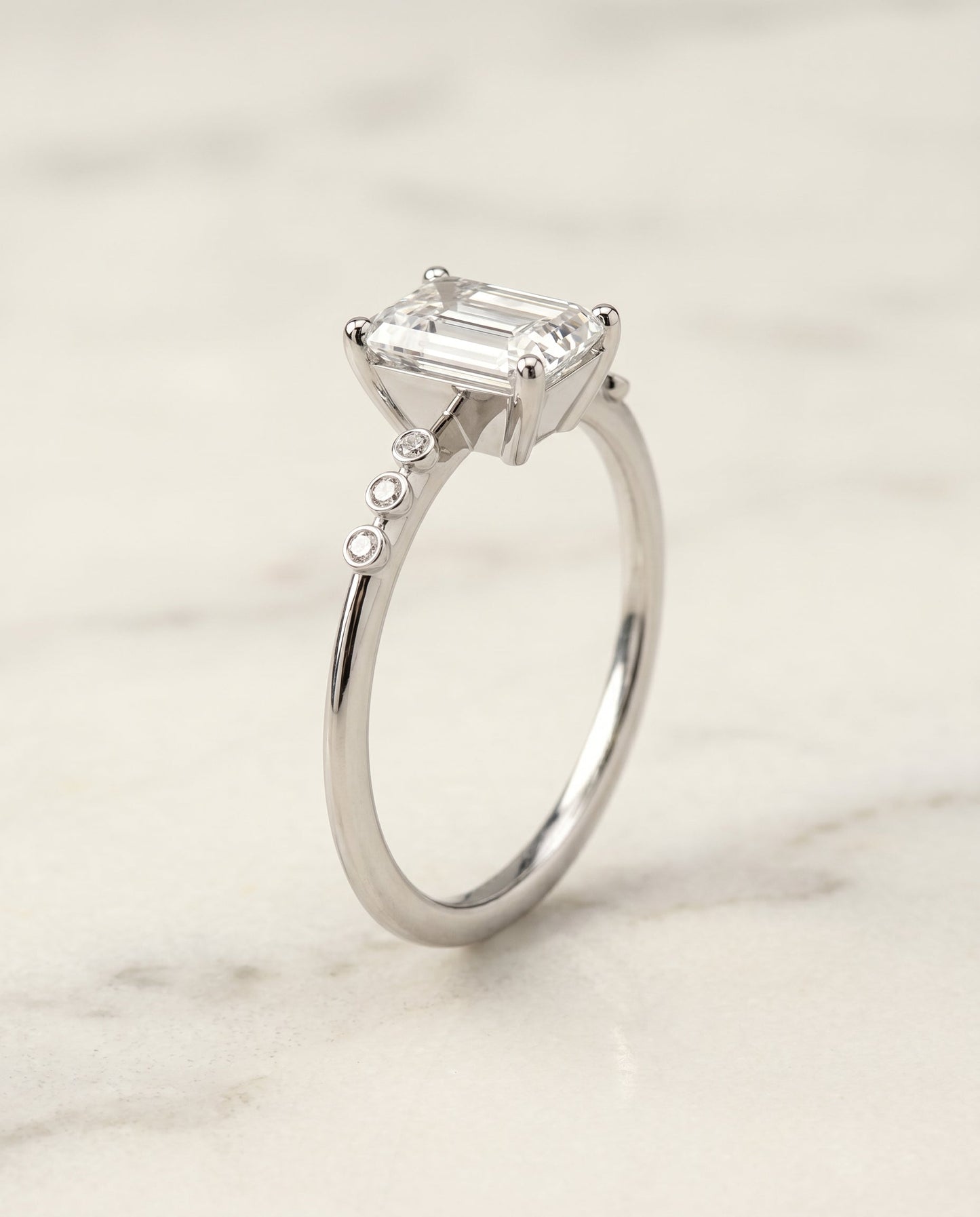 The Peggy Select Bezel Accent Solitaire Emerald Cut Engagement Ring with Lab Diamond in 18K White Gold — view 2