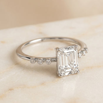 The Peggy Bezel Accent Solitaire Emerald Cut Engagement Ring Setting in Platinum