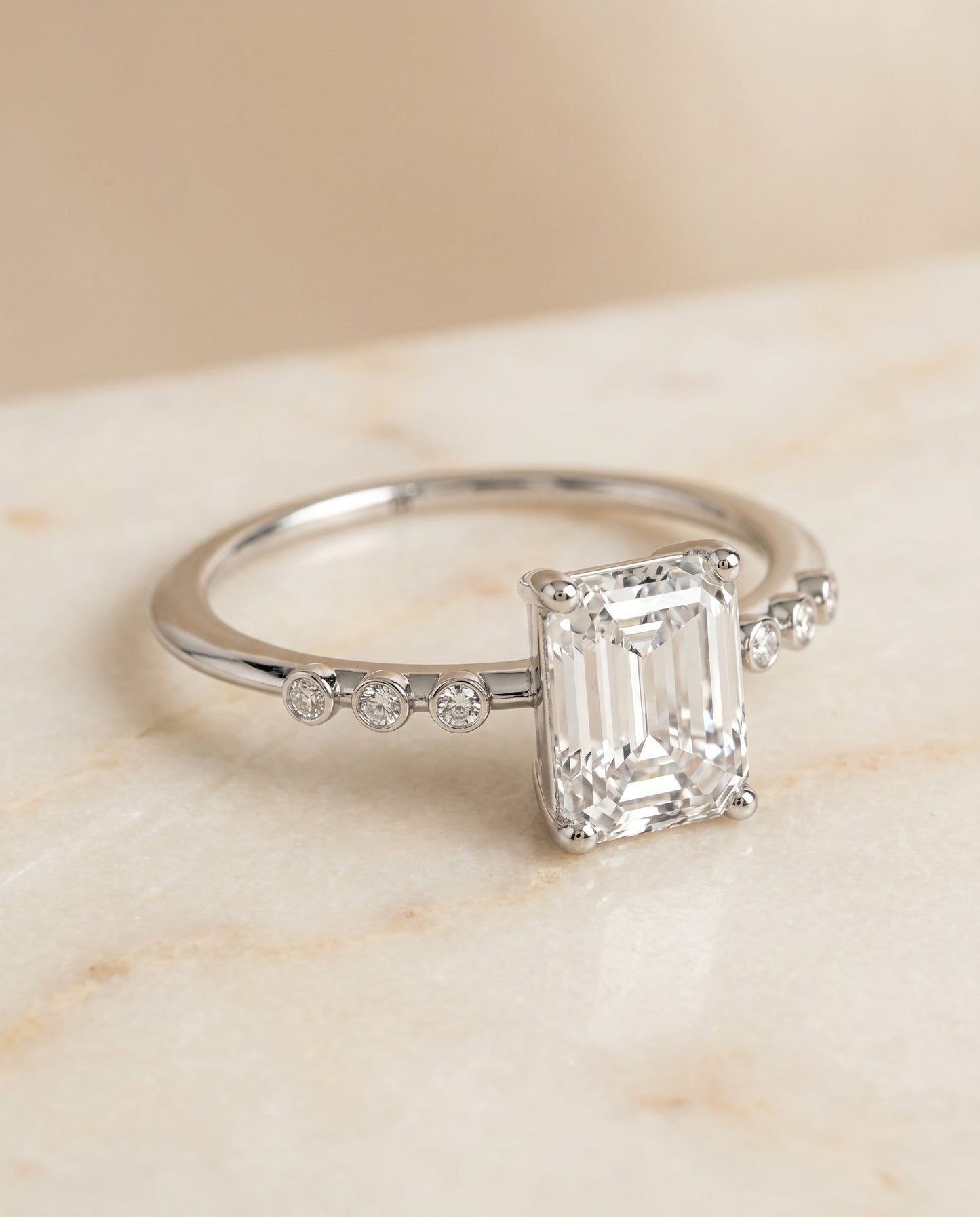 The Peggy Select Bezel Accent Solitaire Emerald Cut Engagement Ring with Lab Diamond in 18K White Gold — view 1