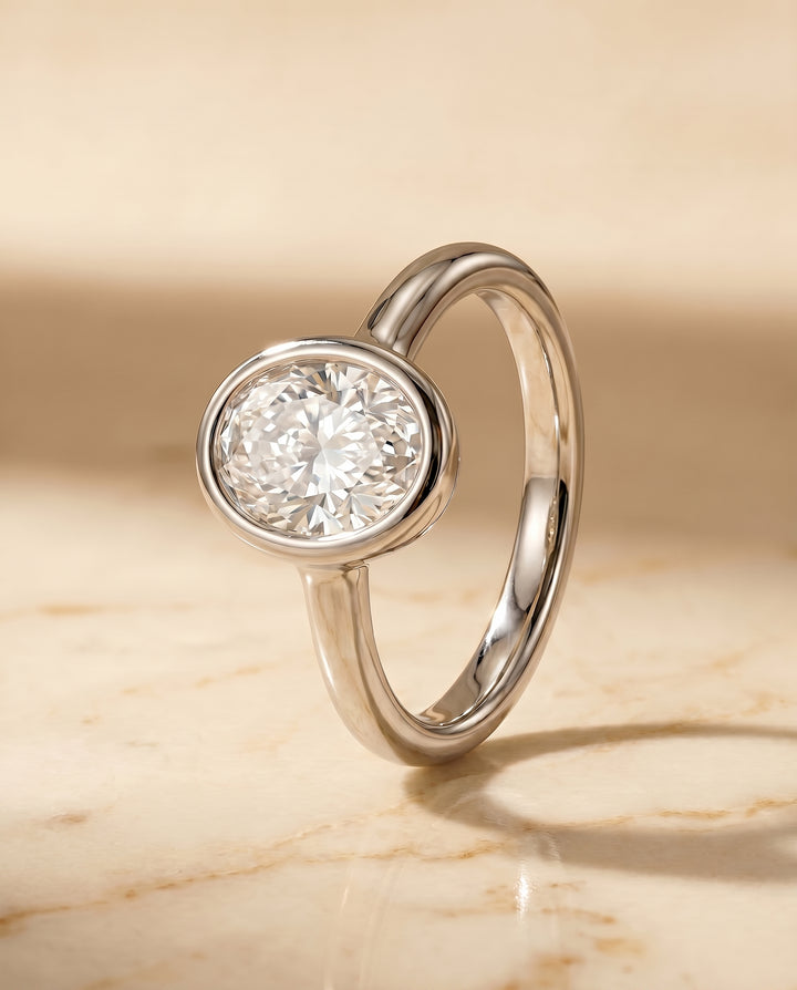 The Agnes Bezel Solitaire Engagement Ring Setting for Oval Diamonds in Platinum