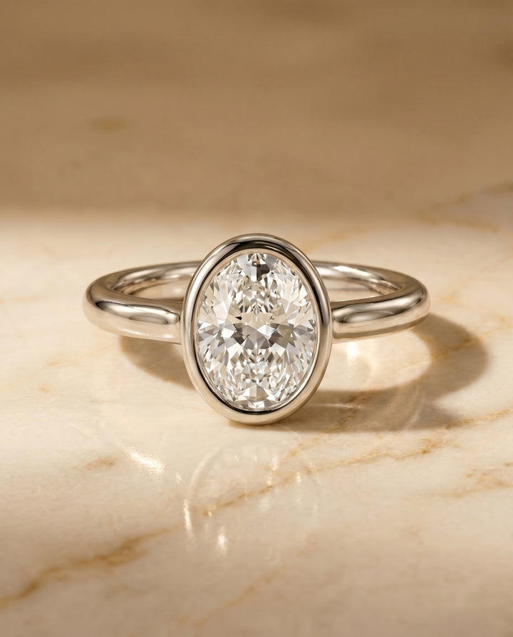 The Agnes Bezel Solitaire Engagement Ring Setting for Oval Diamonds in Platinum | RockHer