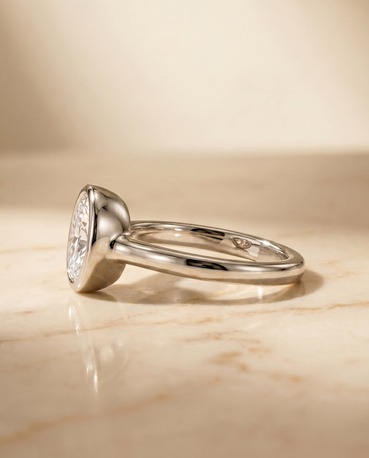 The Agnes Bezel Solitaire Engagement Ring Setting for Oval Diamonds in Platinum