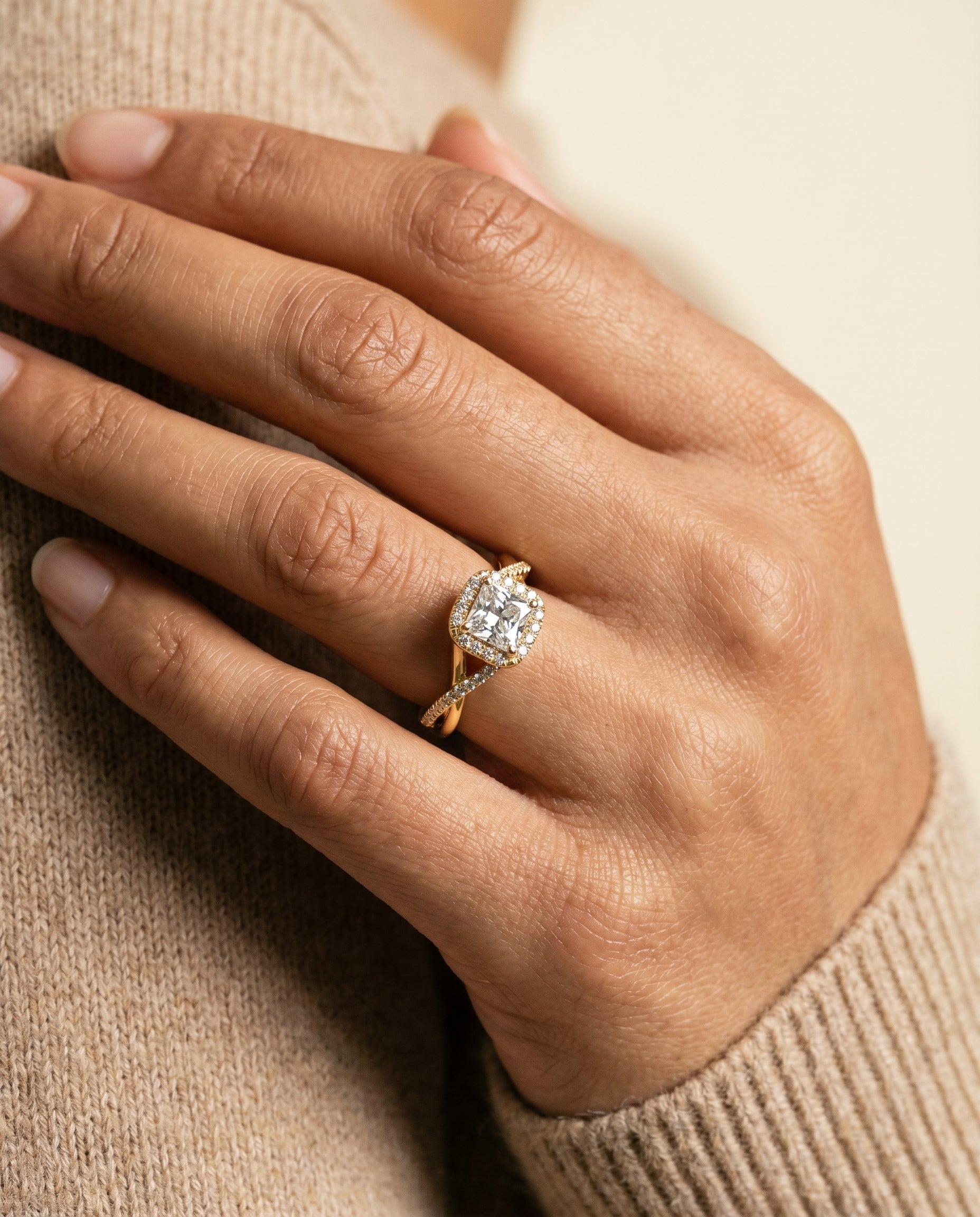Bell Select Bold Twist Pavé Halo Princess Cut Lab Diamond Engagement Ring in 18K Yellow Gold, shown on hand, angled | RockHer