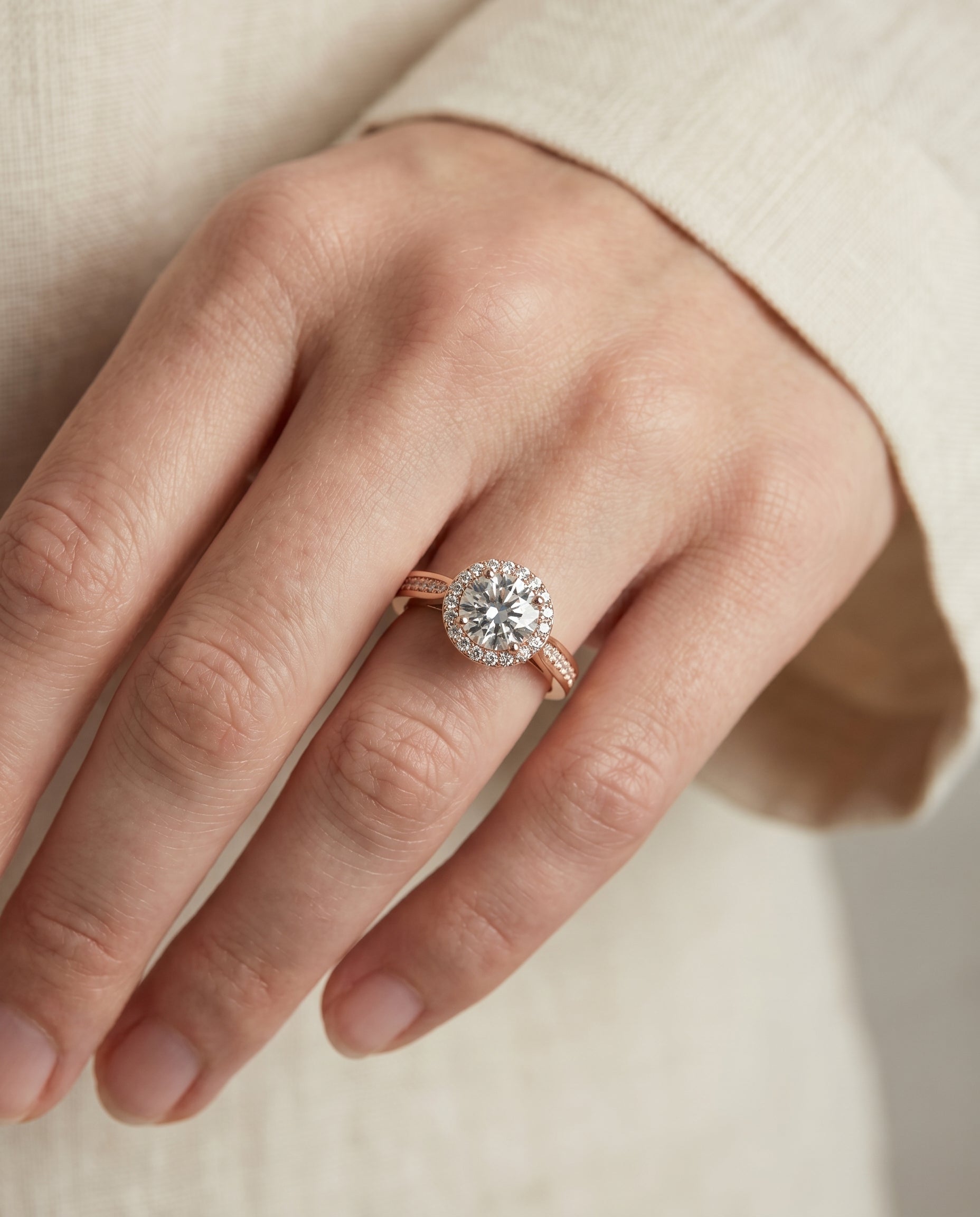 Aria Select Channel Row Pavé Halo Round Lab Diamond Engagement Ring in 14K Rose Gold, shown on hand, angled | RockHer