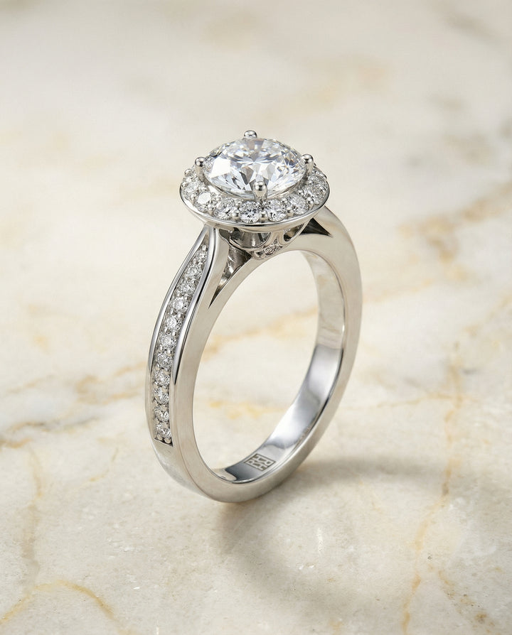 Round Brilliant, Channel Row Pavé Halo, in 18K White Gold, prong setting – front view | RockHer