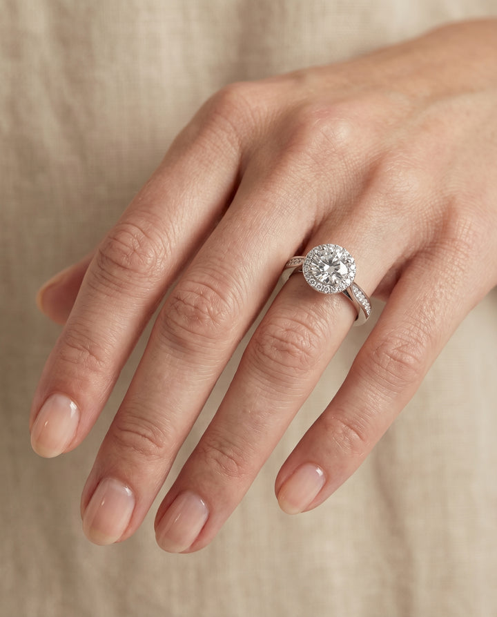 Round Brilliant, Channel Row Pavé Halo, in 18K White Gold, prong setting – lifestyle shot | RockHer