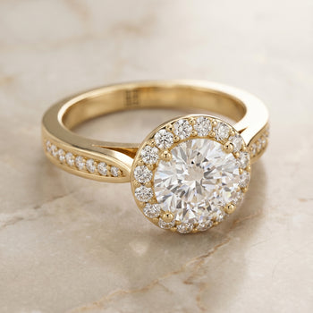 The Aria Channel Row Pavé Halo Round Engagement Ring Setting in 18K Yellow Gold