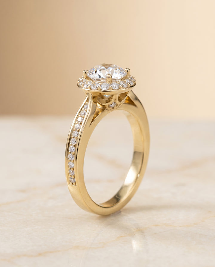 Round Brilliant, Channel Row Pavé Halo, in 18K Yellow Gold, prong setting – front view | RockHer