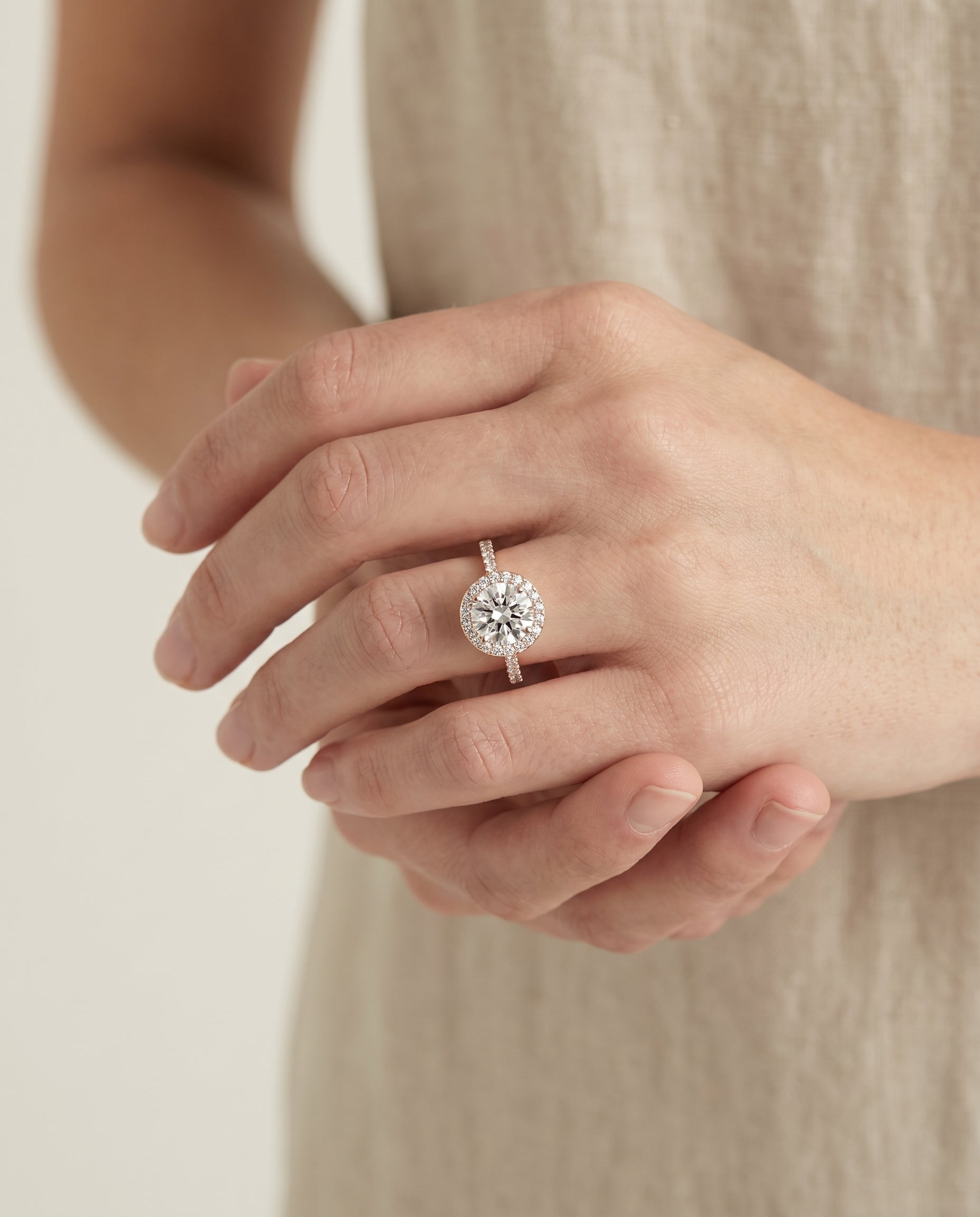 Taylor Select Pavé Halo Round Lab Diamond Engagement Ring in 14K Rose Gold, shown on hand | RockHer