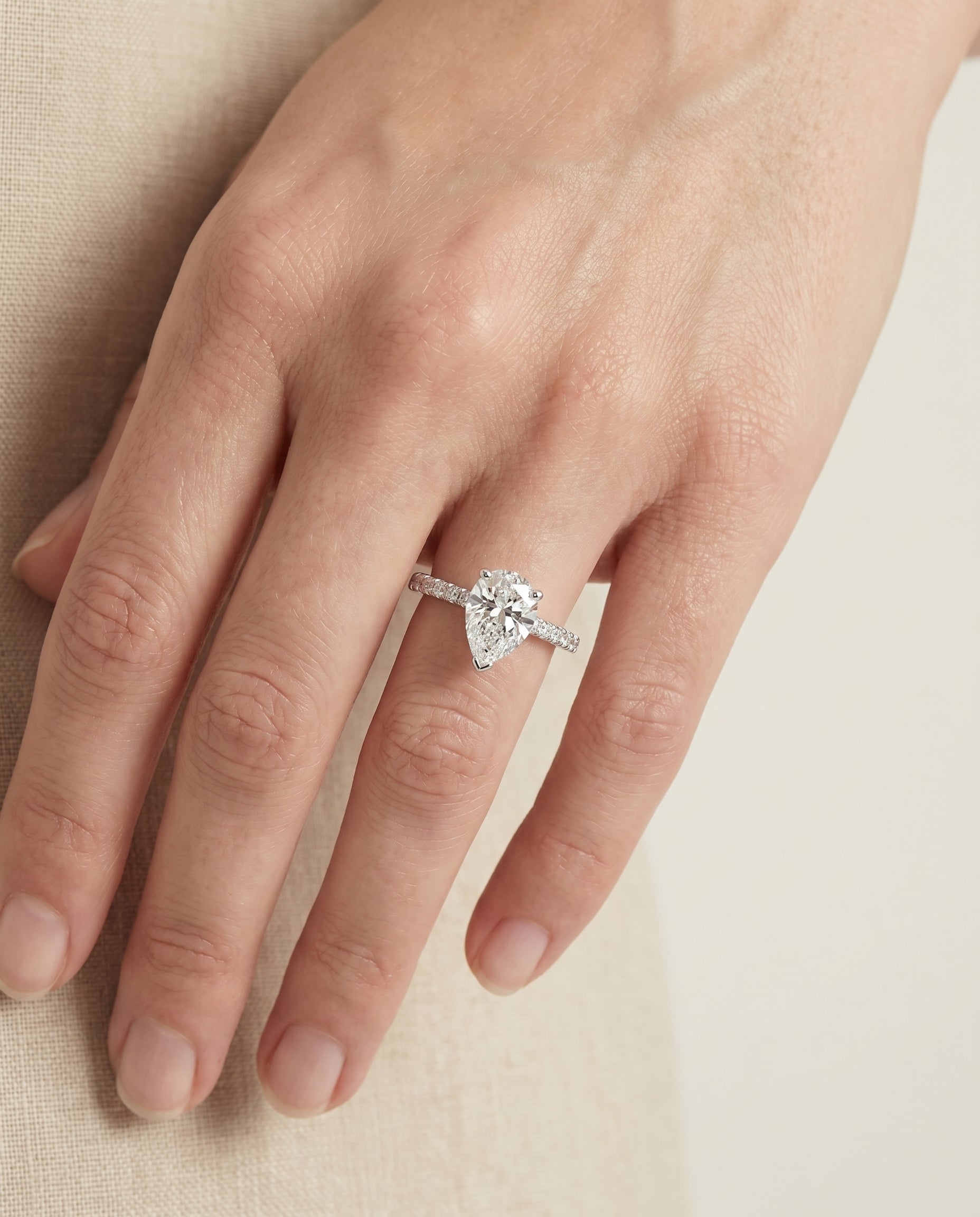 Norah Select Classic Linear French Pavé Pear Lab Diamond Engagement Ring in 18K White Gold, shown on hand | RockHer