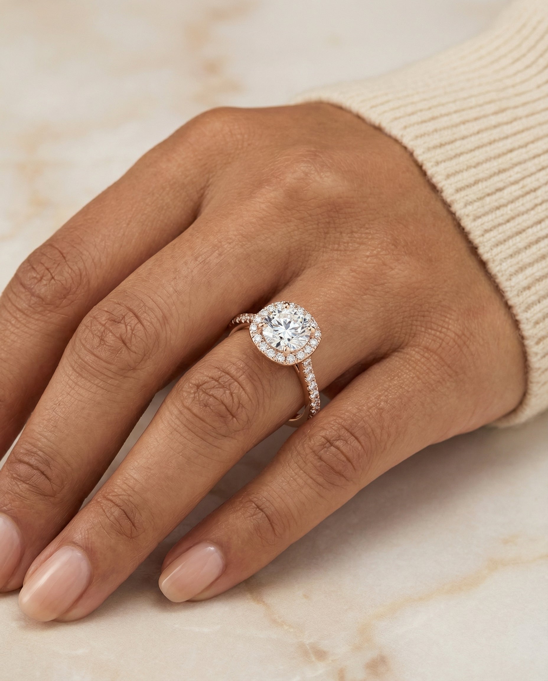Everly Select Classic Shared Prong Halo Round Lab Diamond Engagement Ring in 14K Rose Gold, shown on hand, angled | RockHer