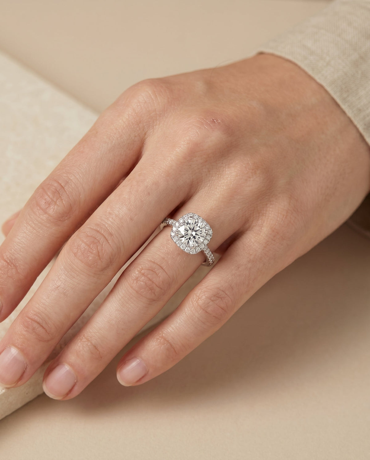Everly Select Pav Halo Round Lab Diamond Engagement Ring in Platinum, shown on hand, angled | RockHer
