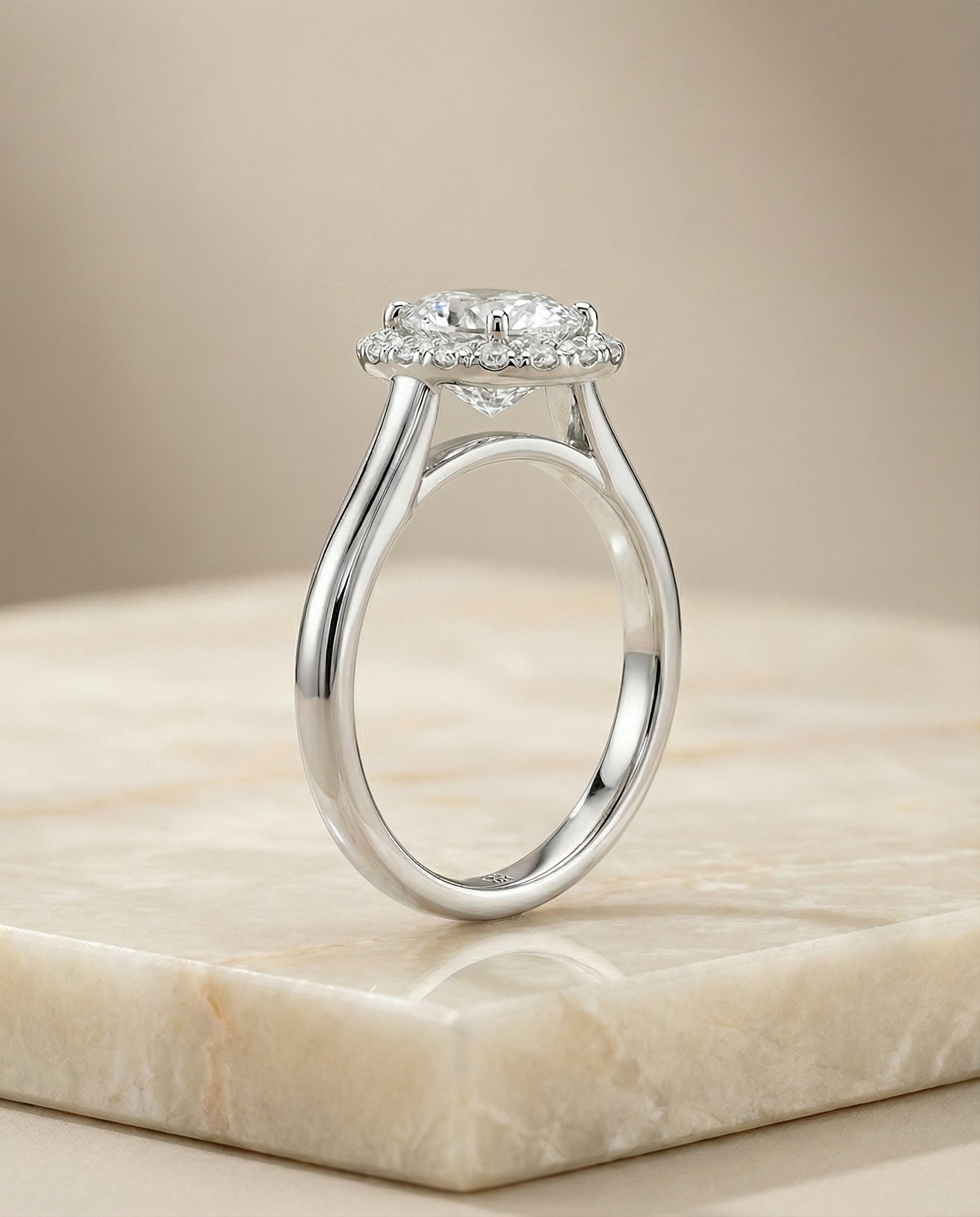 The Etta classic shared prong halo engagement ring setting, shown in Platinum | RockHer