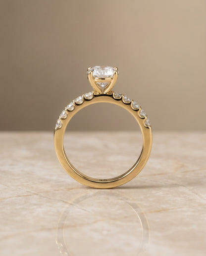 Round Brilliant, Classic Shared Prong Linear Pavé, in 18K Yellow Gold – side profile | RockHer