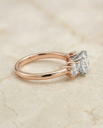 Round Brilliant, Classic Three Stone Round, in 14K Rose Gold, prong setting – side profile | RockHer