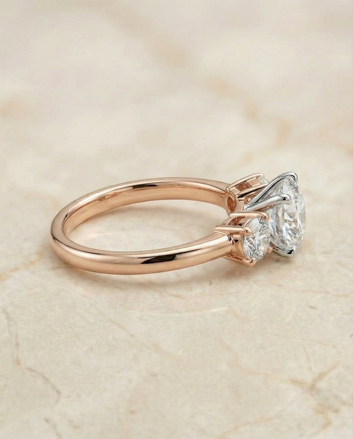 Round Brilliant, Classic Three Stone Round, in 14K Rose Gold, prong setting – side profile | RockHer