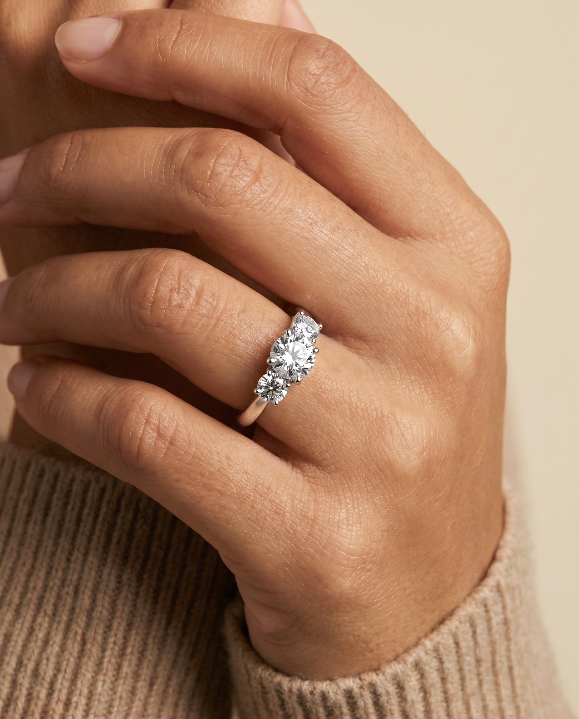 Natalie Select Classic Three Stone Round Lab Diamond Engagement Ring in Platinum, shown on hand, angled | RockHer