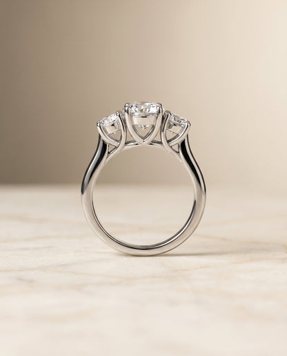Round Brilliant, Classic Three Stone Round, in Platinum, pave setting – side profile | RockHer