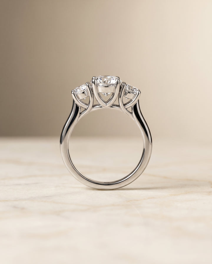 Round Brilliant, Classic Three Stone Round, in Platinum, pave setting – side profile | RockHer