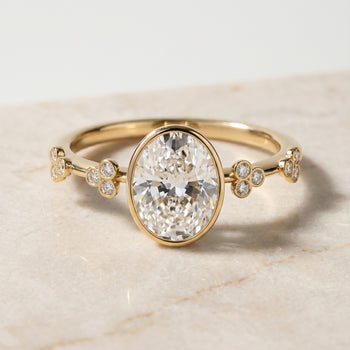 The Miley Clover Bezel Accent Solitaire Oval Engagement Ring Setting in 18K Yellow Gold